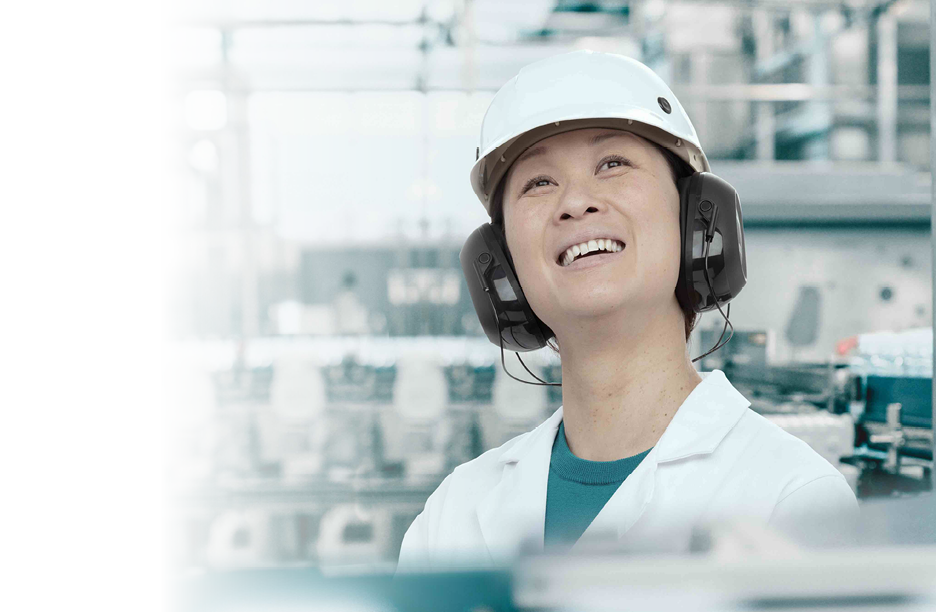 Young Handsome Smiling Scientist With Clipboard Posing in Factory