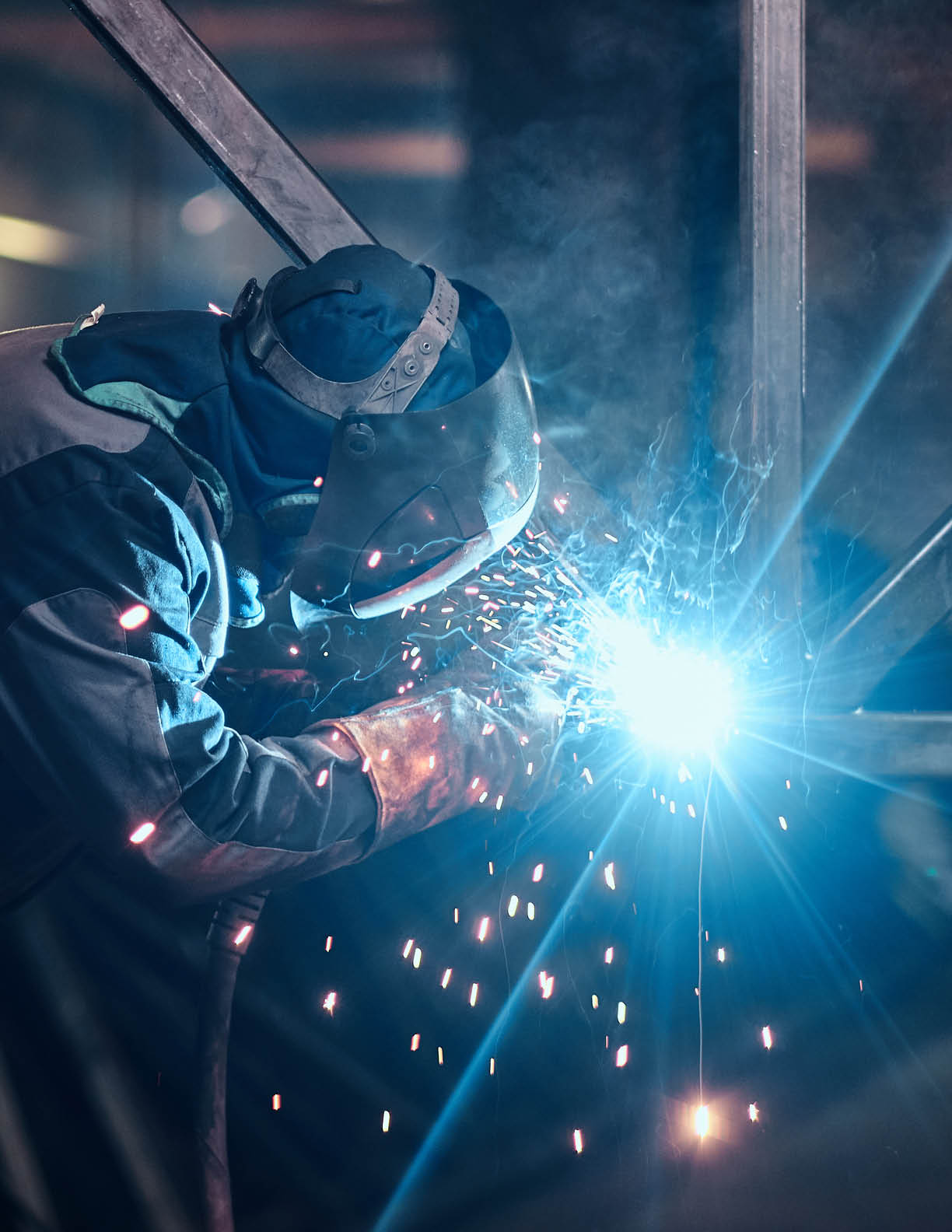 Welding work with metal construction at busy metal factory