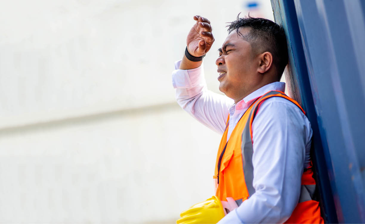 Factory worker man working in hot weather and he look tired from work.