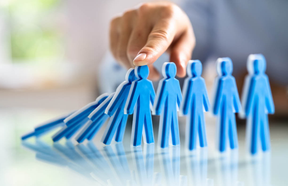Close-up Of A Male Hand Stopping The Persons From Falling On Desk