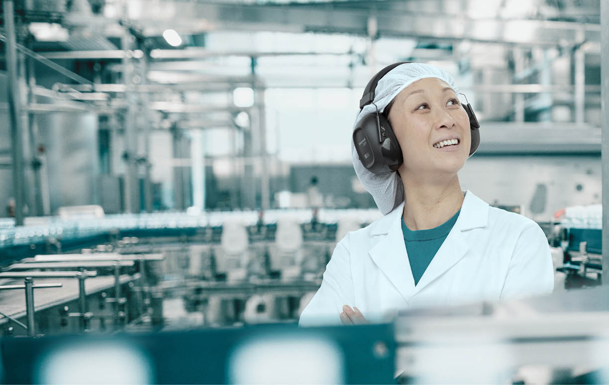 Young Handsome Smiling Scientist With Clipboard Posing in Factory